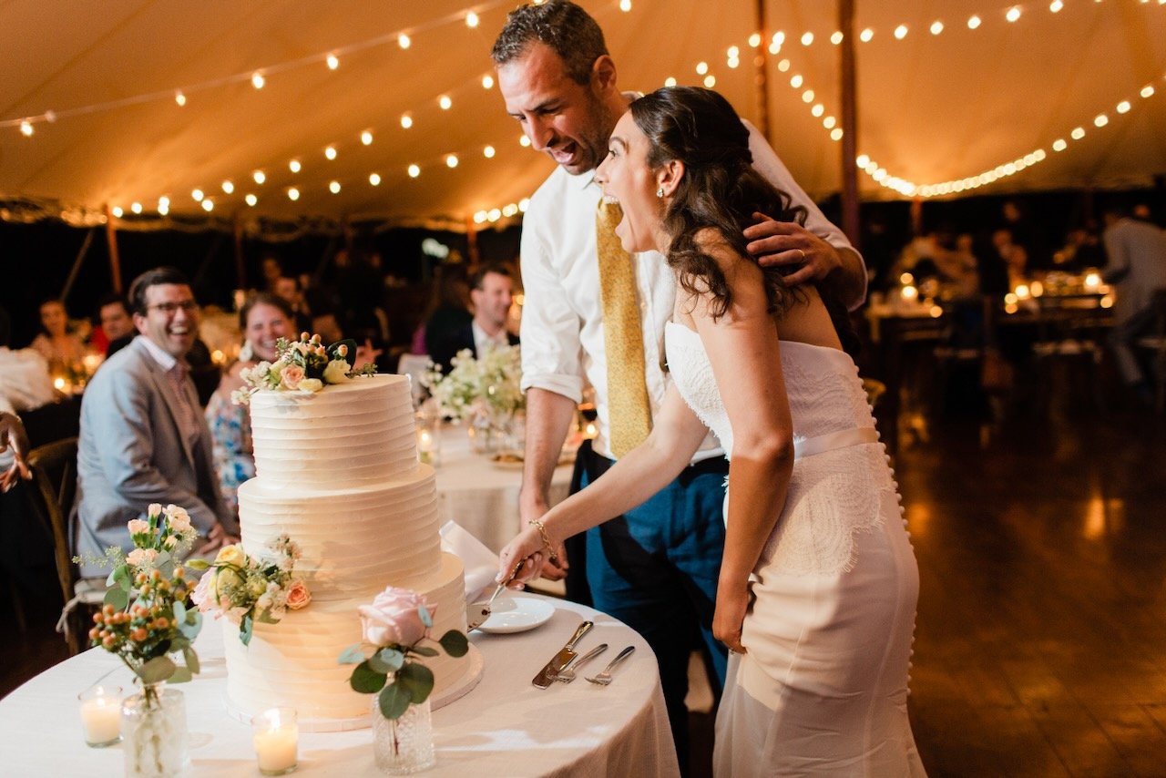 Couple cutting wedding cake